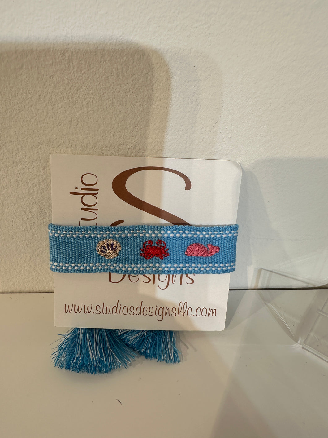 Tassel bracelet with shell crab and a whale